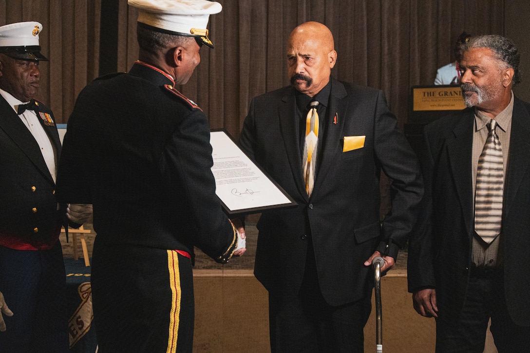 Anthony Smith and his family accept the Congressional Gold Medal on behalf of his father during the U.S. Marine Corps Birthday Ball celebration with the National Montford Point Marine Association, Chapter 8 in Los Angeles, California on Nov. 19, 2022. Montford Point Marines are the first black Marines to enlist in the U.S. Marine Corps and carry their extraordinary legacy of resilience, grit and honor. (U.S. Marine Corps photo by Sgt. Emely Gonzalez)