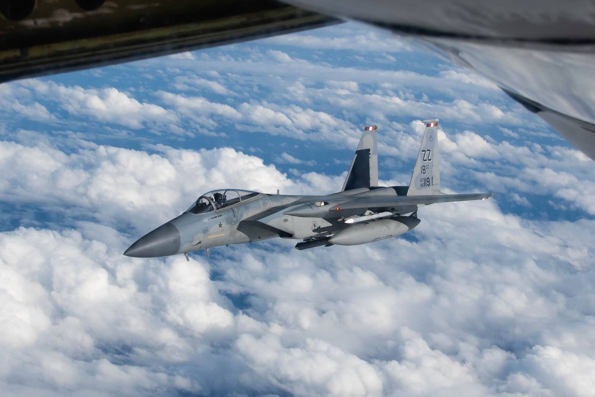 A jet gets refueled in the air.