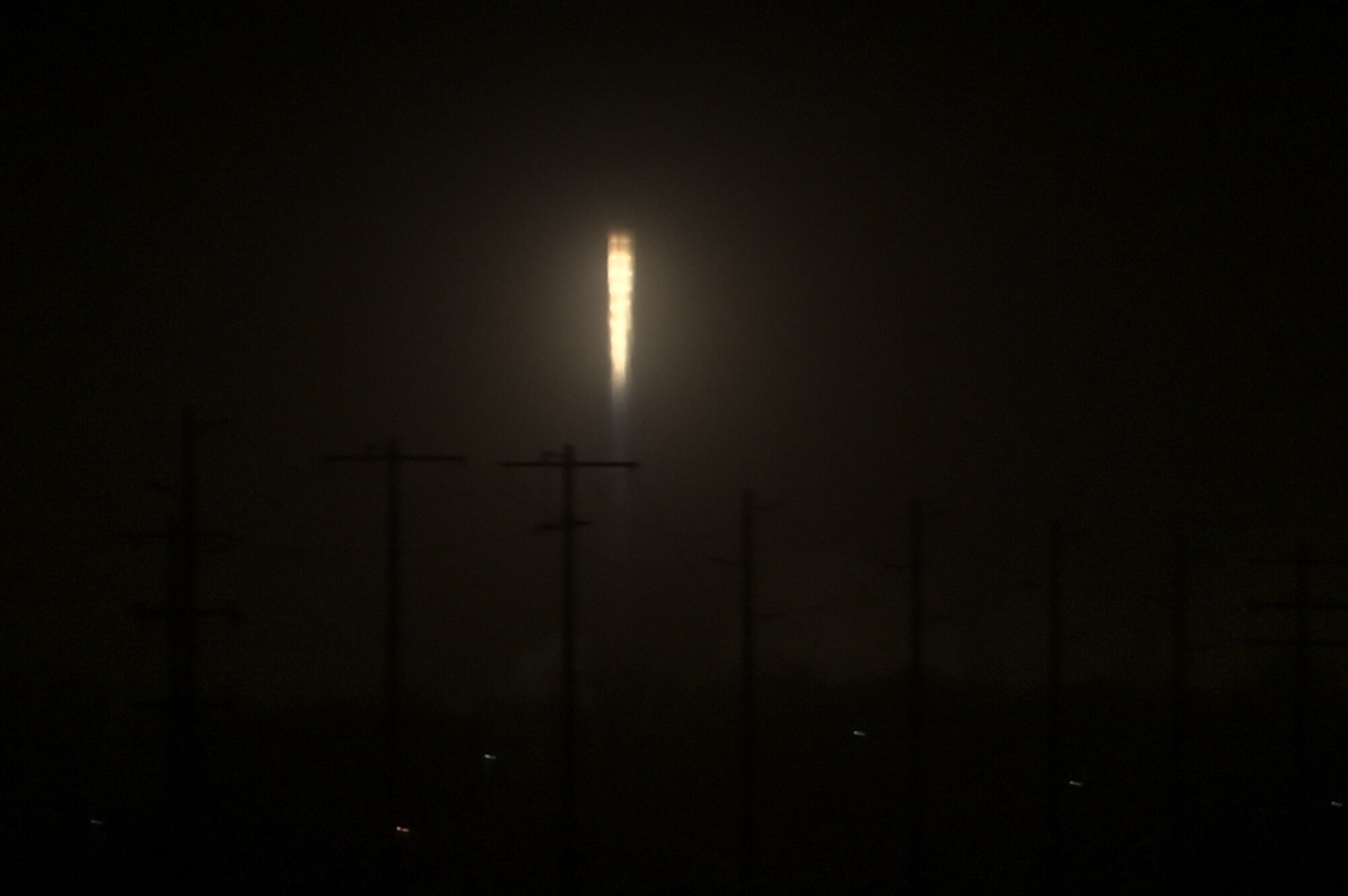 a rocket launches into the sky at night
