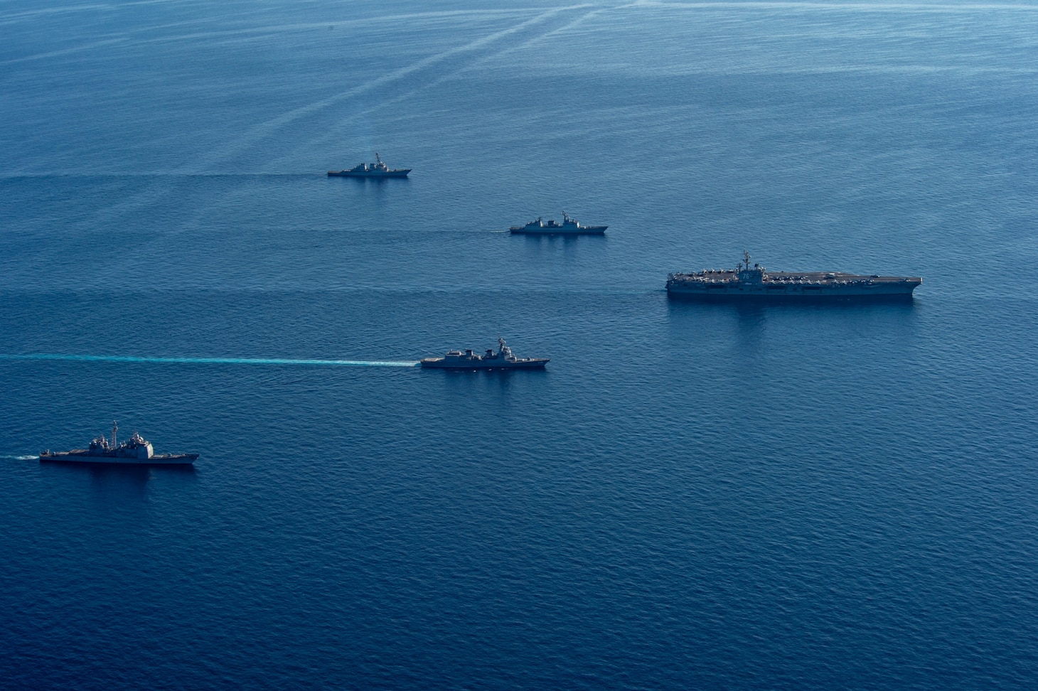 The U.S. Navy’s only forward-deployed aircraft carrier, USS Ronald Reagan (CVN 76), a U.S. Navy Los Angeles-class fast-attack submarine, Ticonderoga-class guided-missile cruiser USS Chancellorsville (CG 62), Arleigh Burke-class guided-missile destroyer USS Benfold (DDG 65), Republic of Korea (ROK) Navy destroyer ROKS Munmu the Great (DDH 976), and Japan Maritime Self-Defense Force (JMSDF) destroyer JS Asahi (DD 119) steam in formation in waters east of the Korean Peninsula, Sept. 30. Ronald Reagan, operating as the flagship of Carrier Strike Group (CSG) 5 is conducting a trilateral anti-submarine warfare exercise with the JMSDF and ROK Navy. The operations between the Reagan Strike Group, JS Asahi, and ROKS Munmu The Great, involved operating with a U.S. submarine to enhance interoperability between the nations in support of a free and open Indo-Pacific.