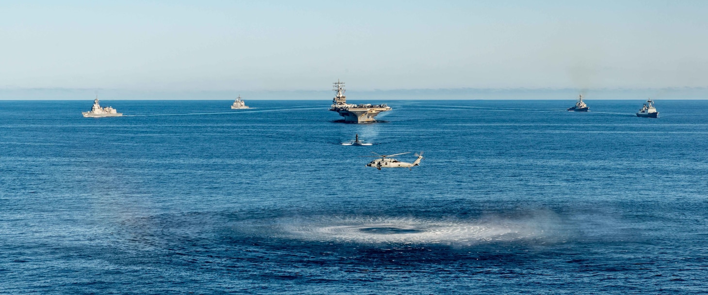 An MH-60S Sea Hawk attached to the Golden Falcons of Helicopter Sea Combat Squadron (HSC) 12, hovers in front of the U.S. Navy’s only forward-deployed aircraft carrier, USS Ronald Reagan (CVN 76), a U.S. Navy Los Angeles-class fast-attack submarine, Ticonderoga-class guided-missile cruiser USS Chancellorsville (CG 62), Arleigh Burke-class guided-missile destroyer USS Benfold (DDG 65), Republic of Korea (ROK) Navy destroyer ROKS Munmu the Great (DDH 976) and Japan Maritime Self-Defense Force (JMSDF) destroyer JS Asahi (DD 119), as they steam in formation in waters east of the Korean Peninsula, Sept. 30. Ronald Reagan, operating as the flagship of Carrier Strike Group (CSG) 5 is conducting a trilateral anti-submarine warfare exercise with the JMSDF and ROK Navy. The operations between the Reagan Strike Group, JS Asahi, and ROKS Munmu The Great, involved operating with a U.S. submarine to enhance interoperability between the nations in support of a free and open Indo-Pacific.