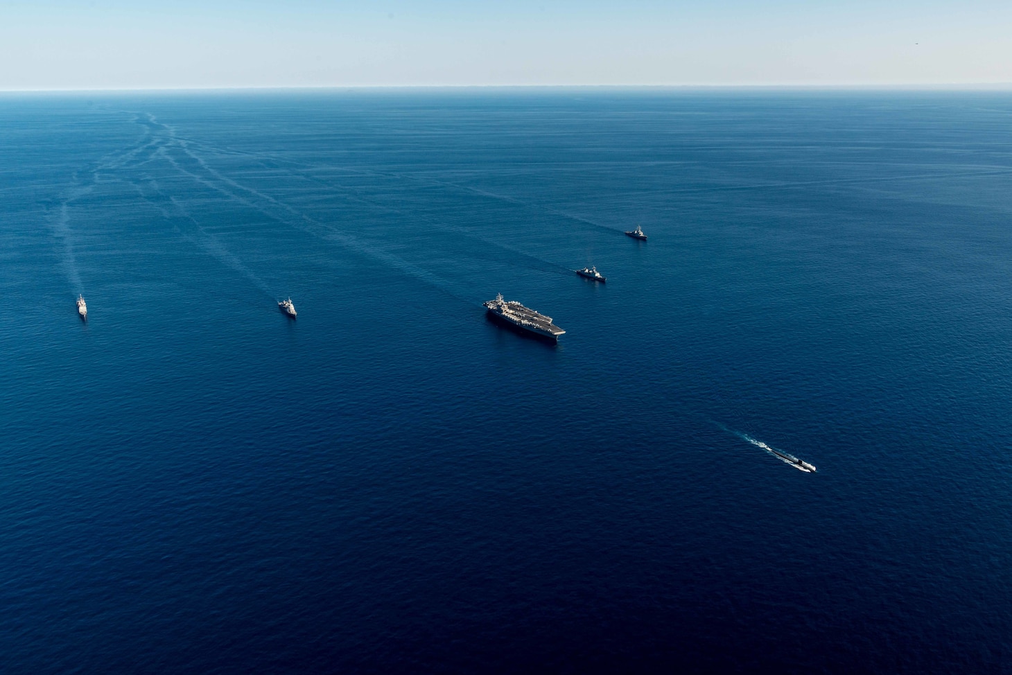 The U.S. Navy’s only forward-deployed aircraft carrier, USS Ronald Reagan (CVN 76), a U.S. Navy Los Angeles-class fast-attack submarine, Ticonderoga-class guided-missile cruiser USS Chancellorsville (CG 62), Arleigh Burke-class guided-missile destroyer USS Benfold (DDG 65), Republic of Korea (ROK) Navy destroyer ROKS Munmu the Great (DDH 976) and Japan Maritime Self-Defense Force (JMSDF) destroyer JS Asahi (DD 119), steam in formation in waters east of the Korean Peninsula, Sept. 30. Ronald Reagan, operating as the flagship of Carrier Strike Group (CSG) 5 is conducting a trilateral anti-submarine warfare exercise with the JMSDF and ROK Navy. The operations between the Reagan Strike Group, JS Asahi, and ROKS Munmu The Great, involved operating with a U.S. submarine to enhance interoperability between the nations in support of a free and open Indo-Pacific.
