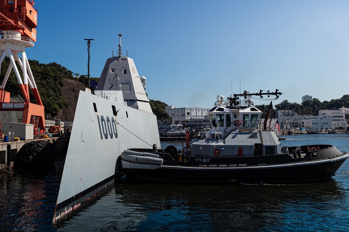 The Valiant-class harbor tugs Puyallup (YT-806) and Menominee (YT-807), assigned to Commander, Fleet Activities Yokosuka (CFAY), escort the guided-missile destroyer USS Zumwalt (DDG 1000) to a berth at CFAY for a scheduled port visit.