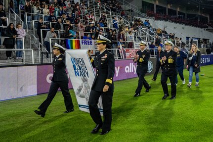 WASHINGTON (Oct. 01, 2022) - Chief of Naval Operations Adm. Mike Gilday and Sailors and civilians assigned to Navy Sea Systems command participate in the halftime parade during a National Women's Soccer League game at Audi Field where the Washington Spirit highlighted Women in the Navy (WIN), Oct. 1. During the game, between the Washington Spirit and the Houston Dash, Navy women, which included Sailors and civilians, were recognized on the field for their service. (U.S. Navy photo by Mass Communication Specialist 1st Class Michael B. Zingaro/released)