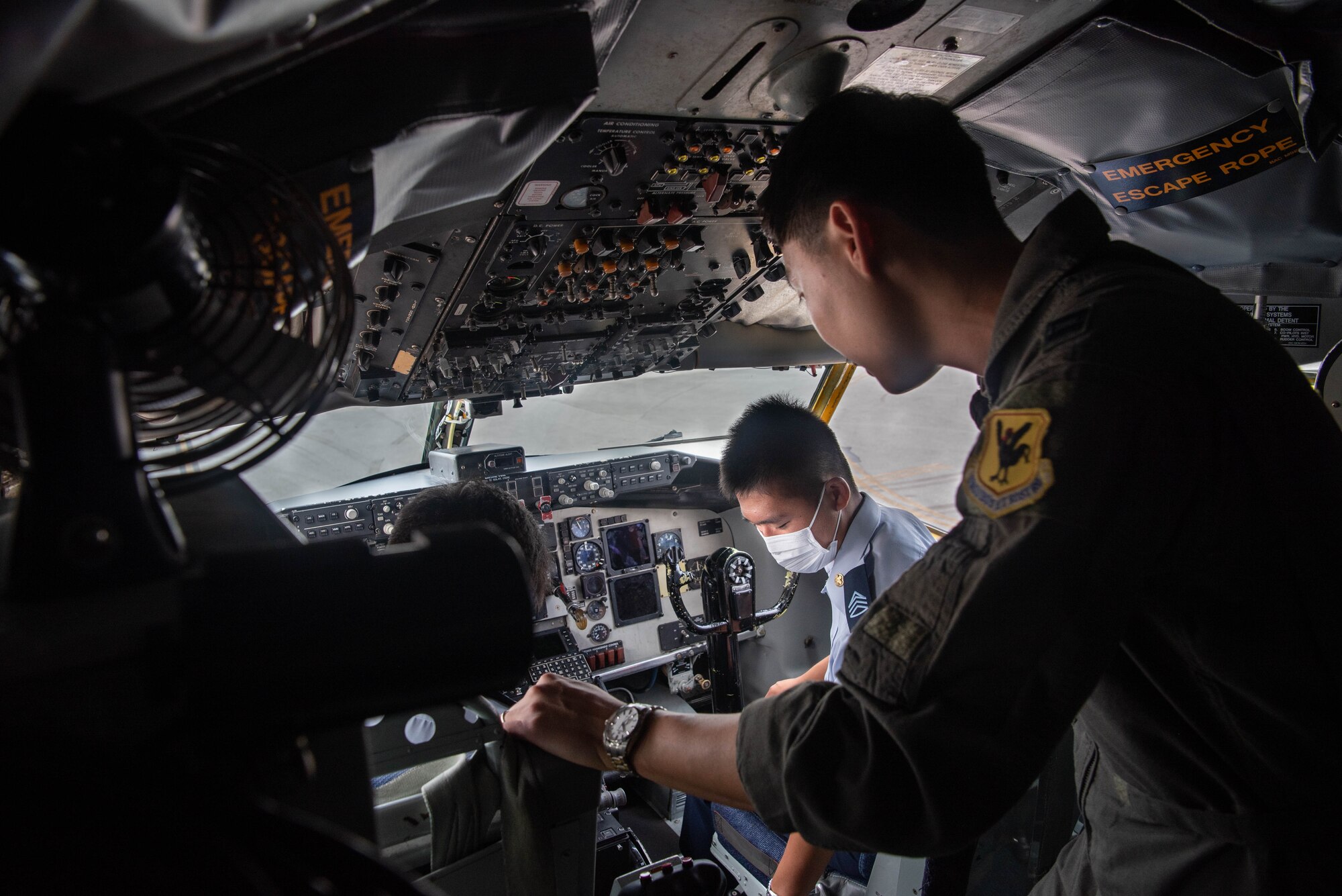 JASDF cadets sit in a cock pit.