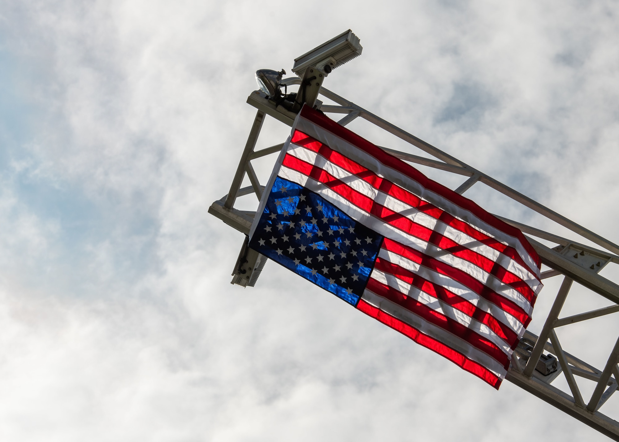 U.S. flag hangs from a fire truck aerial