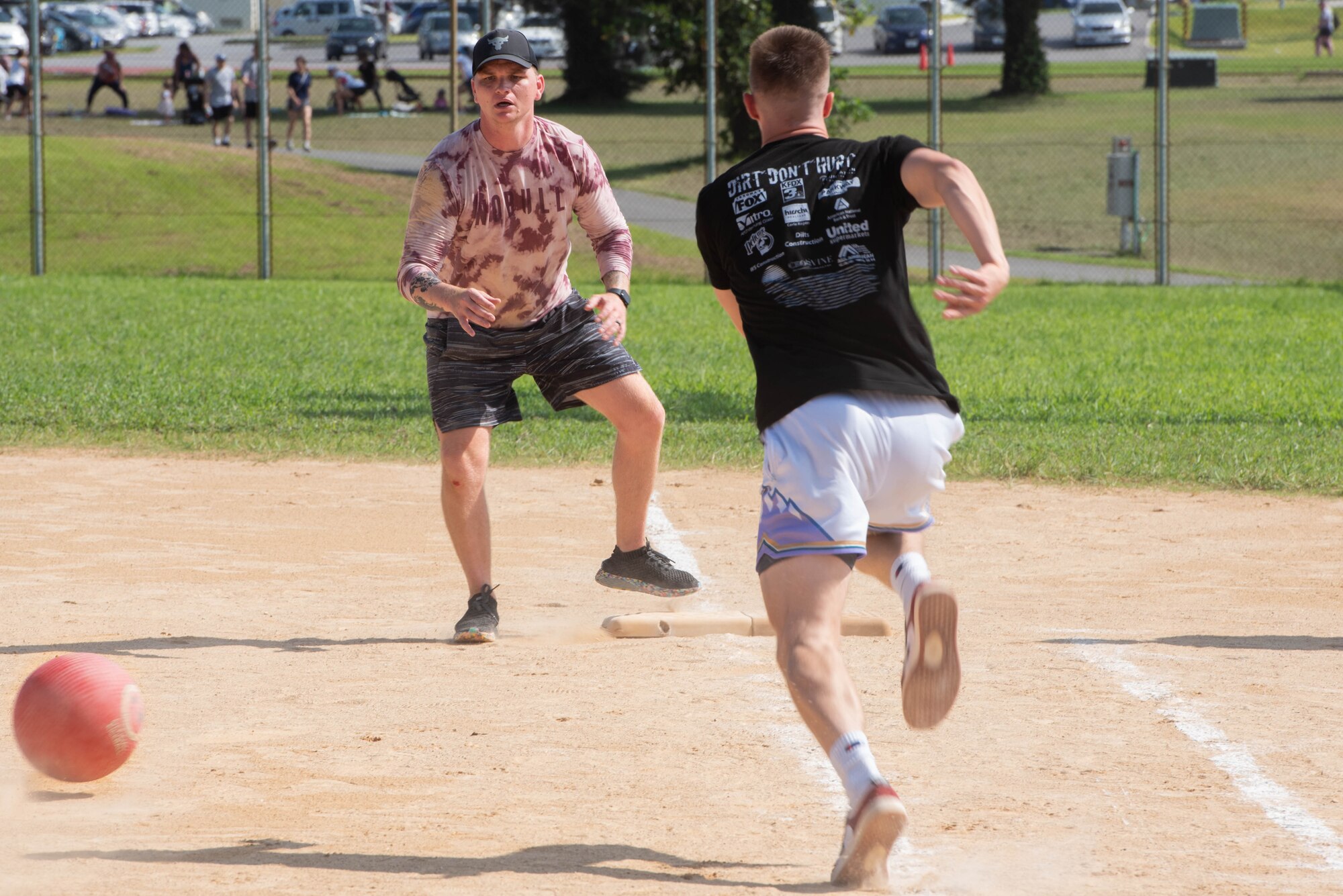 An Airman runs to first base in a game of kickball.