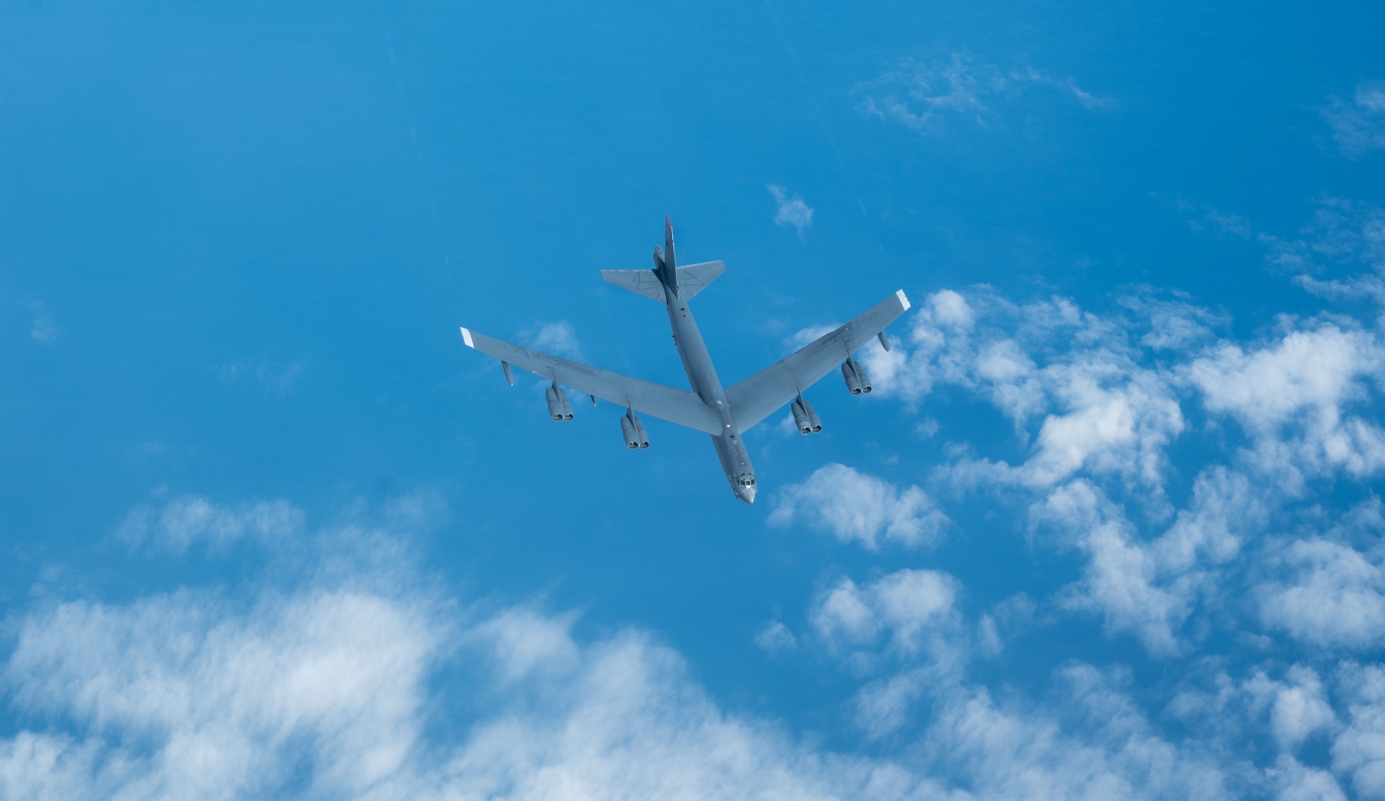 Plane flies in the sky.