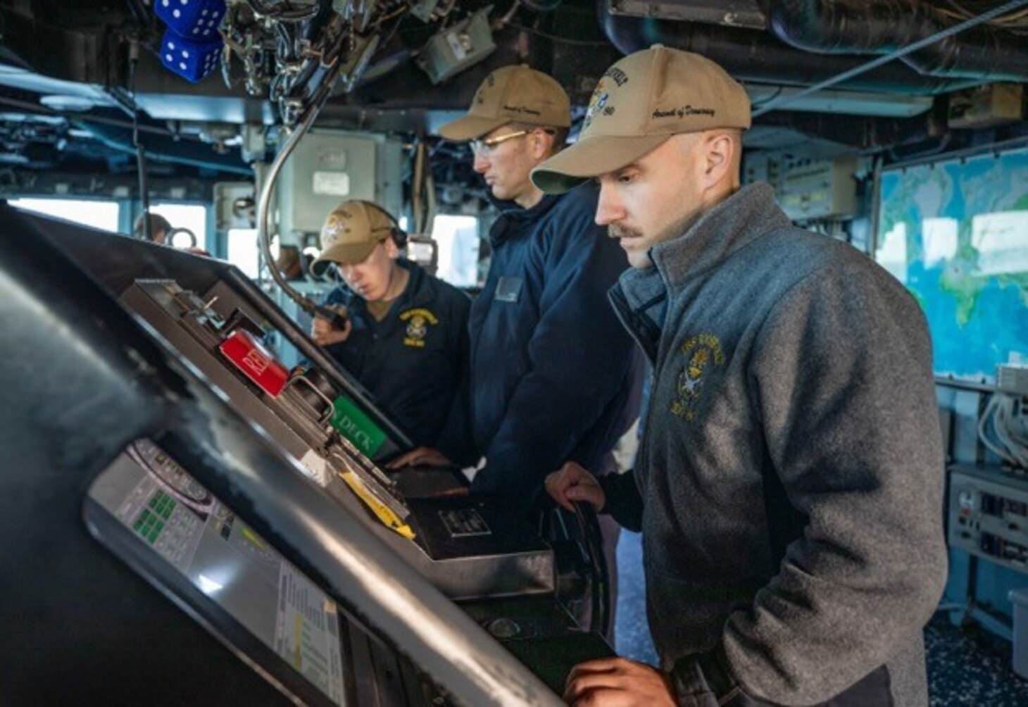 Sailors steer the Arleigh Burke-class guided-missile destroyer USS Roosevelt (DDG 80) as the ship conducts a replenishment-at-sea with dry cargo ship USNS William McLean (T-AKE 12), Oct. 1, 2022.