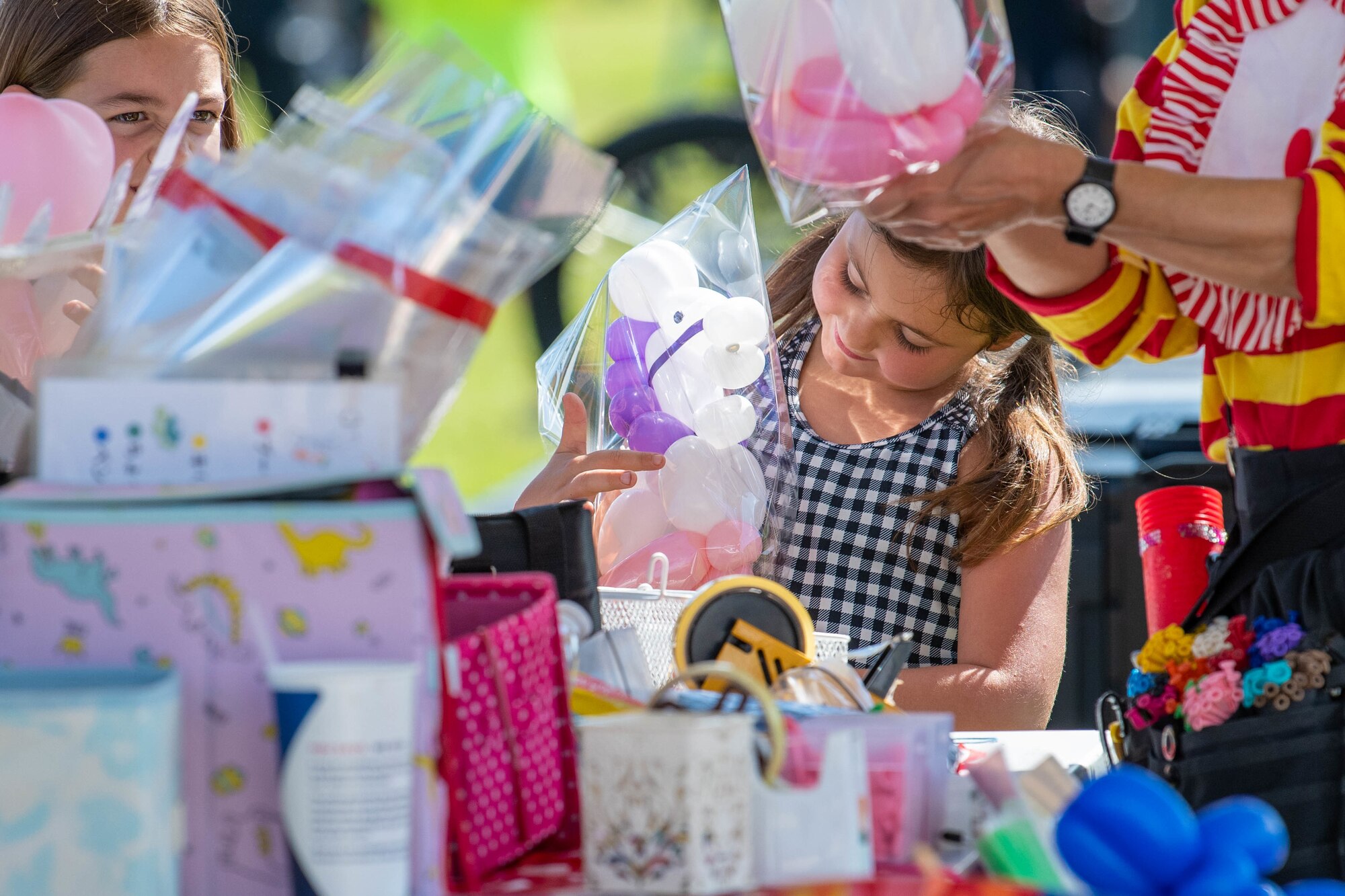 A little girl receives a balloon animal