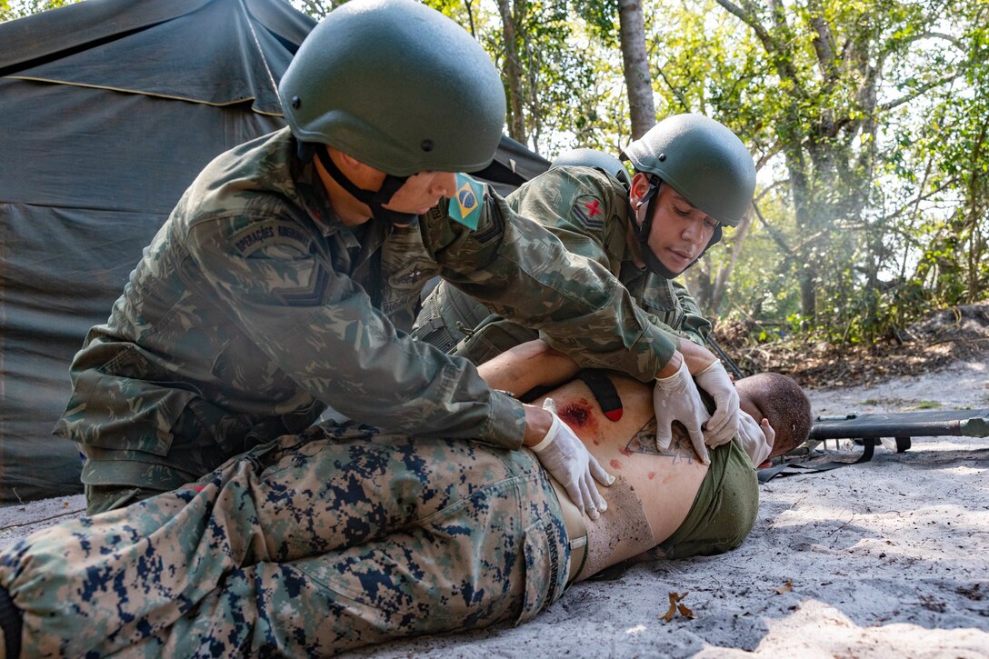Brazilian marines perform a simulated casualty evacuation at a surgical training event during exercise UNITAS LXIII in Marambaia, Brazil, Sept. 10, 2022. The training event consisted of a medical equipment presentation, a field surgery, and a CASEVAC via a Brazilian armored personnel carrier. UNITAS is the world’s longest-running annual multinational maritime exercise that focuses on enhancing interoperability among multiple nations and joint forces during littoral and amphibious operations in order to build on existing regional partnerships and create new enduring relationships that promote peace, stability, and prosperity in the U.S. Southern Command’s area of responsibility. (U.S. Marine Corps photo by Lance Cpl. David Intriago)