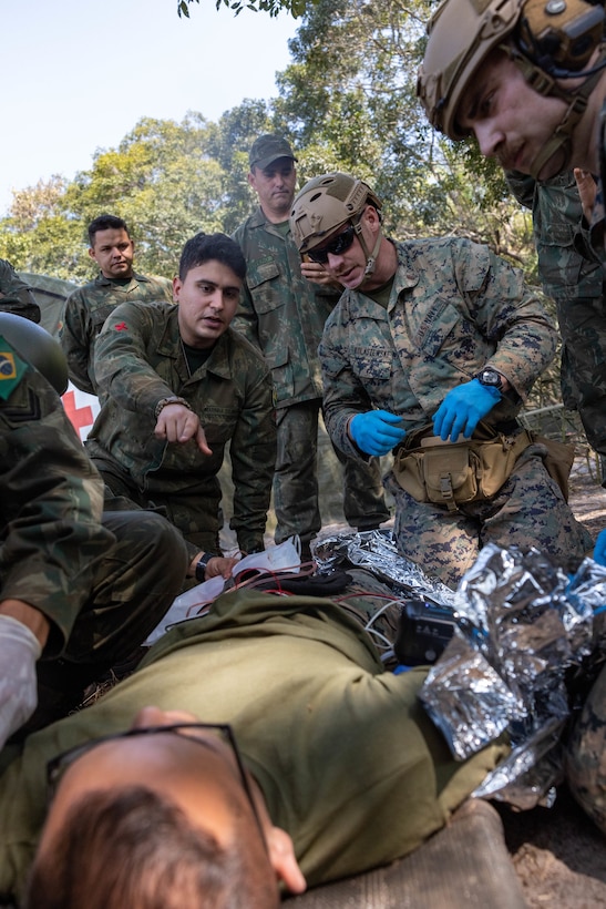 U.S. Sailors with 2nd Medical Battalion, 2nd Marine Logistics Group, in support of Special Purpose Marine Air-Ground Task Force UNITAS LXIII discuss medical treatment with Brazilian marines while participating in a surgical training event during exercise UNITAS LXIII in Marambaia, Brazil, Sept. 10, 2022. The training event consisted of a medical equipment presentation, a field surgery, and a casualty evacuation via a Brazilian armored personnel carrier. UNITAS, which is Latin for “unity,” was conceived in 1959 and has taken place annually since first conducted in 1960. This year marks the 63rd iteration of the world’s longest-running annual multi-national maritime exercise. Additionally, this year Brazil celebrated its bicentennial, a historical milestone commemorating 200 years of the country’s independence. (U.S. Marine Corps photo by Lance Cpl. David Intriago)