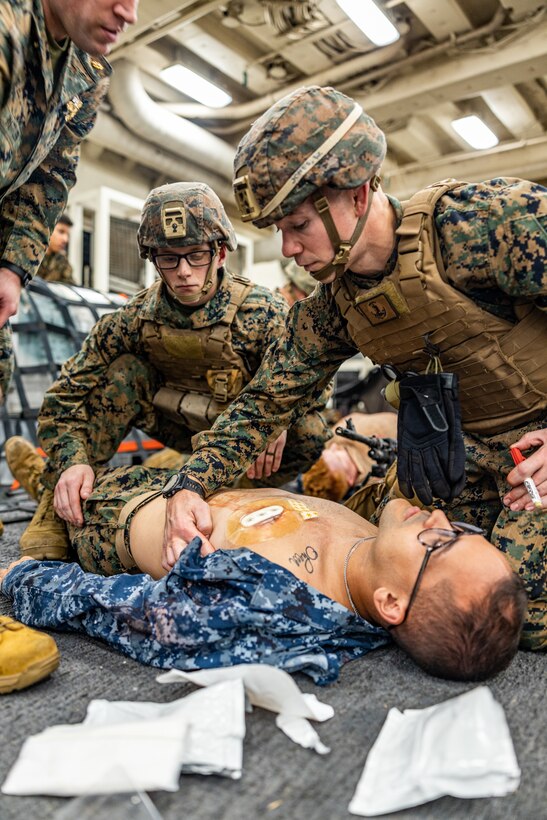 U.S. Navy Hospital Corpsman 2nd Class Will Jones, right, attached with 4th Light Armored Reconnaissance Battalion, 4th Marine Division and U.S. Marine Lance Cpl. Christophe Marlin Jr., left, a rifleman with India Company, 3rd Battalion, 25th Marine Regiment, 4th Marine Division in support of Special Marine Air-Ground Task Force UNITAS LXIII renders aid to a simulated casualty on a Marine during combat casualty care drill while aboard the amphibious transport dock ship USS Mesa Verde (LPD 19) during exercise UNITAS LXIII in the Atlantic Ocean, Sept. 17, 2022. Practical application of tactical combat casualty care ensures Marines and Corpsmen can apply essential life saving techniques in a timely and efficient manner. UNITAS, which is Latin for “unity,” was conceived in 1959 and has taken place annually since first conducted in 1960. This year marks the 63rd iteration of the world’s longest-running annual multi-national maritime exercise. Additionally, this year Brazil celebrated its bicentennial, a historical milestone commemorating 200 years of the country’s independence. (U.S. Marine Corps photo by Cpl. Ryan Schmid)