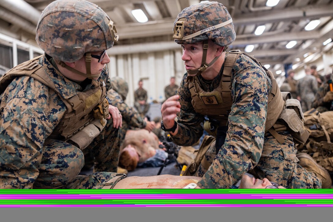 U.S. Navy Hospital Corpsman 2nd Class Will Jones, right, attached 4th Light Armor Reconnaissance Battalion, 4th Marine Division and U.S. Marine Lance Cpl. Christophe Marlin Jr., left, a rifleman with India Company, 3rd Battalion, 25th Marine Regiment, 4th Marine Division in support of Special Marine Air-Ground Task Force UNITAS LXIII renders aid to a simulated casualty on a Marine during a combat casualty care drill while aboard the amphibious transport dock ship USS Mesa Verde (LPD 19) during exercise UNITAS LXIII in the Atlantic Ocean, Sept. 17, 2022. Practical application of tactical combat casualty care ensures Marines and Corpsmen can apply essential life saving techniques in a timely and efficient manner. UNITAS trains forces to conduct joint maritime operations through the execution of anti-surface, anti-submarine, anti-air, amphibious and electronic warfare operations that enhance warfighting proficiency and increase interoperability among participating navy and marine forces. (U.S. Marine Corps photo by Cpl. Ryan Schmid)