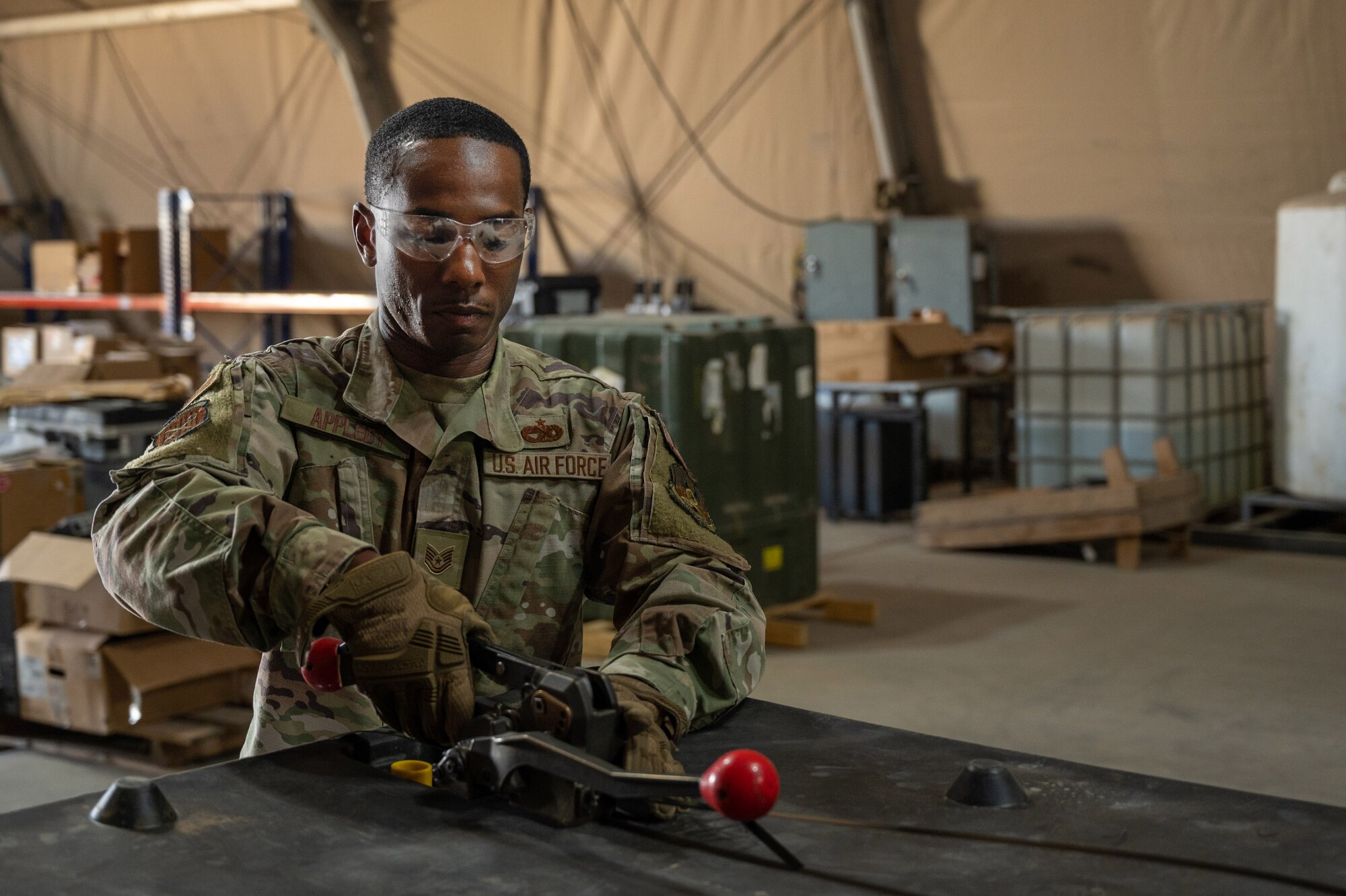 “Warrior of the Week,” Tech Sgt. Stanley Appleby, Non-Commissioned Officer in Charge, 332d Expeditionary Logistics Readiness Squadron, packages a tri/wall package at the 332d Aerial Expeditionary Wing at an undisclosed location in Southwest Asia, September 27, 2022. Appleby earned recognition for his many contributions to the mission in addition to his work as the Non-Commissioned Officer In Charge of the Expeditionary Logistics Readiness Squadron. (U.S. Air Force photo by: Tech. Sgt. Richard Mekkri)