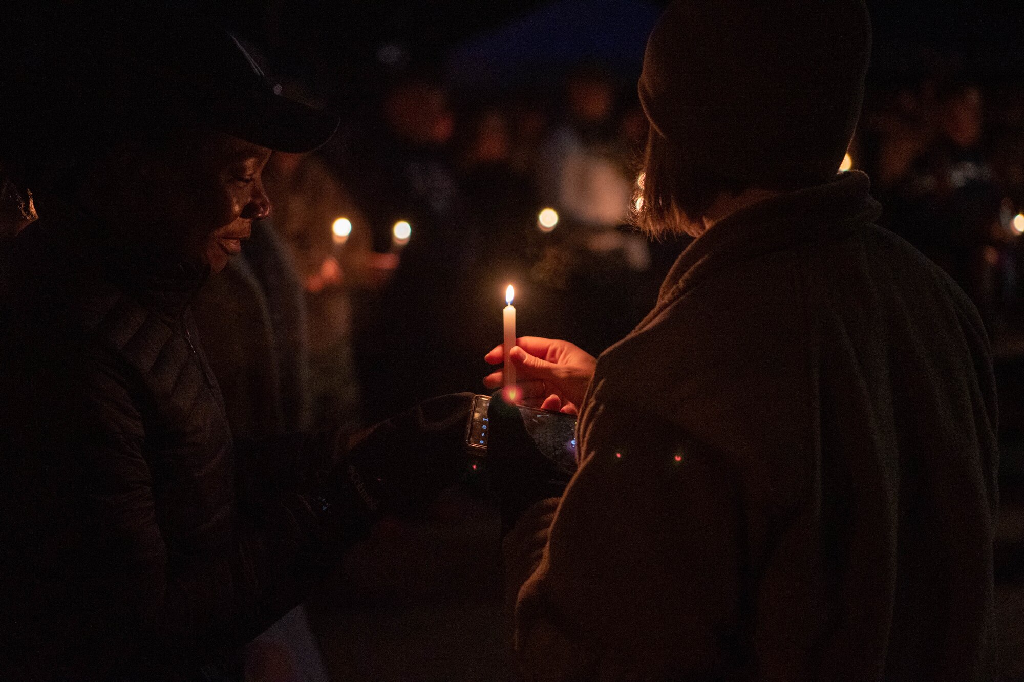 People stand together and hold candles.