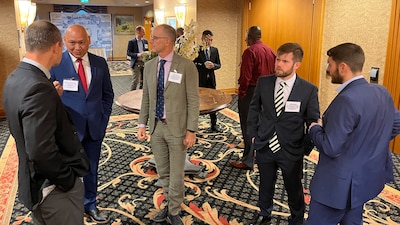 gentlemen talking in a conference space