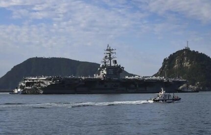 USS Ronald Reagan (CVN 76), a Nimitz-class supercarrier, arrives in port at Busan, Republic of Korea.