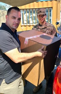 Personnel assigned to the U.S. Army Medical Materiel Center-Korea deliver boxes of ancillary kits for COVID-19 vaccine and booster administration to USS Ronald Reagan (CVN 76) during a Sept. 23 port visit to Busan, Republic of Korea. (U.S. Army photo by Staff Sgt. Camanita Ieremia)