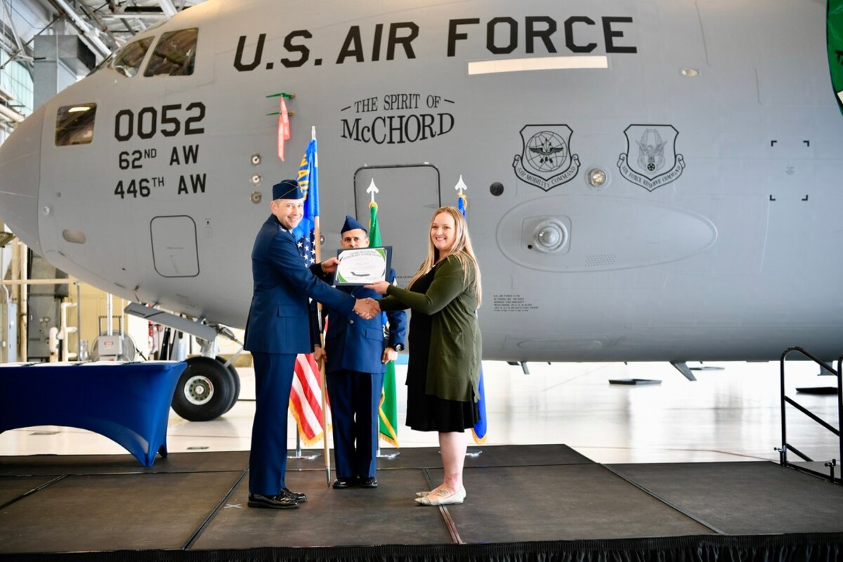 certificate presentation in front of a C-17