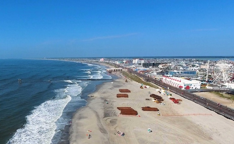The U.S. Army Corps of Engineers and its contractor conduct dredging and beachfill operations in July 2020 in Ocean City, N.J. Work is designed to reduce the risk of coastal storm damages to infrastructure.