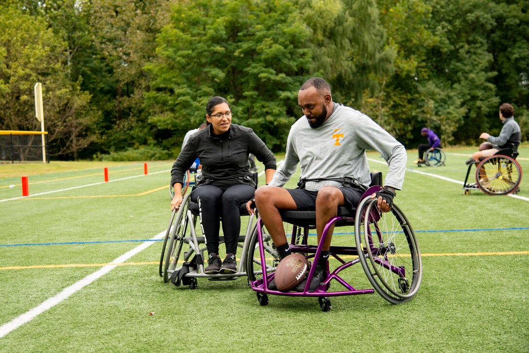 Athletes practice wheelchair football skills.