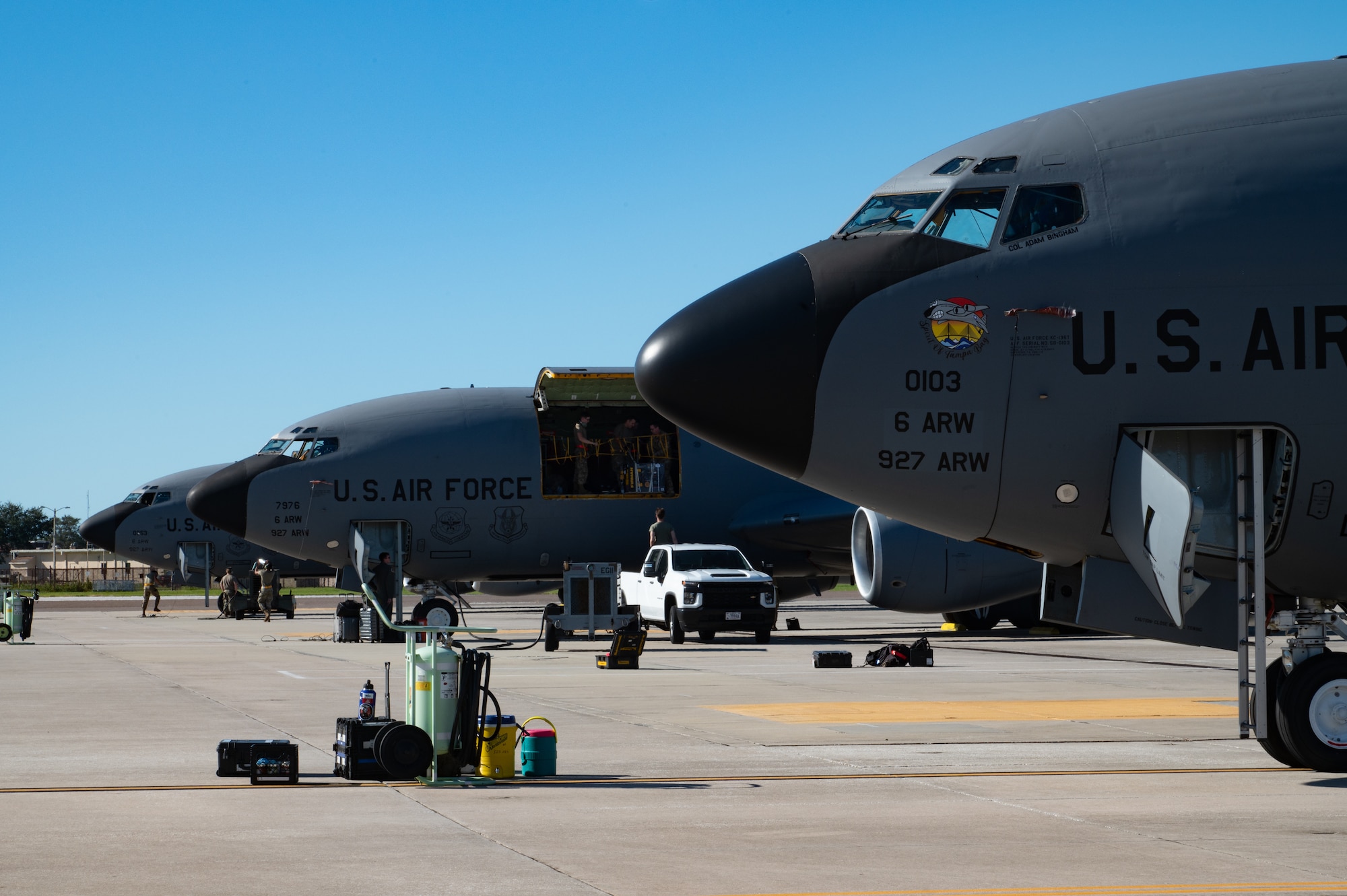 Three U.S. Air Force KC-135 Stratotankers remain dormant on the flightline