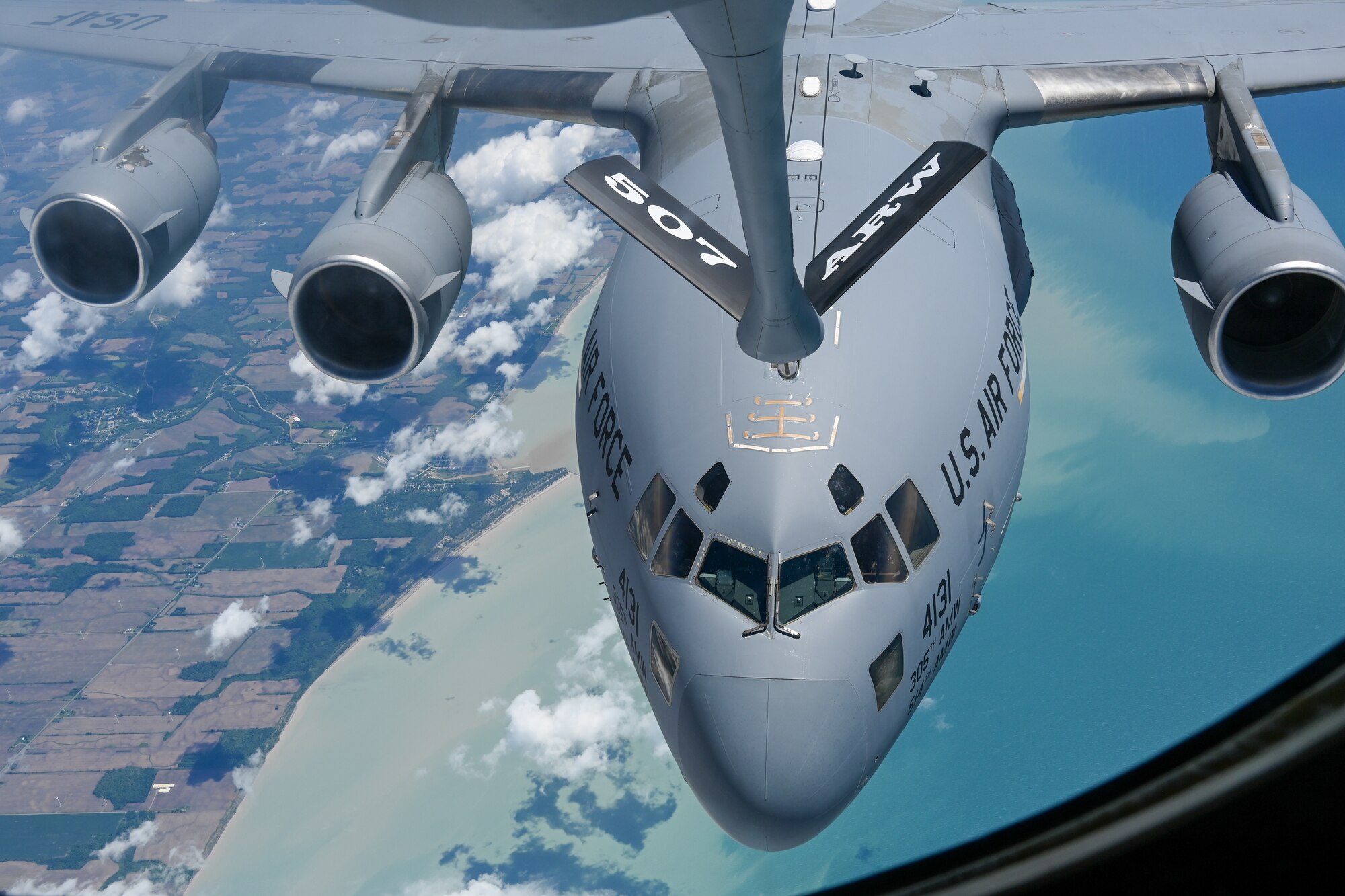 A C-17 Globemaster assigned to the 305th Air Mobility Wing, Joint Base McGuire-Dix-Lakehurst, New Jersey, refuels with a KC-135 Stratotanker from the 465th Air Refueling Squadron, Tinker Air Force Base, Oklahoma, over the Atlantic Ocean, June 9, 2022. (U.S. Air Force photo by 2nd Lt. Mary Begy)