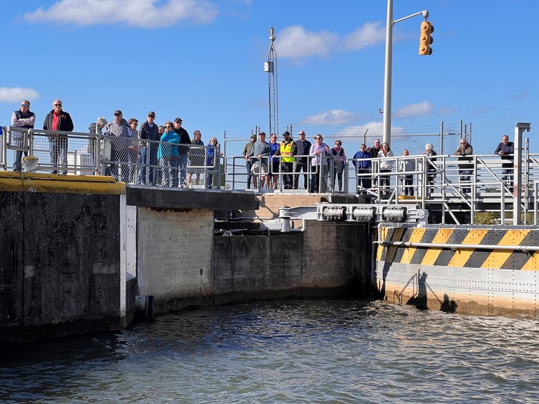 Lock Operator Josh Shockey (wearing reflective vest) leads a tour Sept. 29, 2022, of Fort Loudoun Lock on the Tennessee River in Lenoir City, Tennessee. The Tellico Village New Villagers were learning about navigation and what it takes to maintain and operate the lock. (USACE Photo by Lee Roberts)