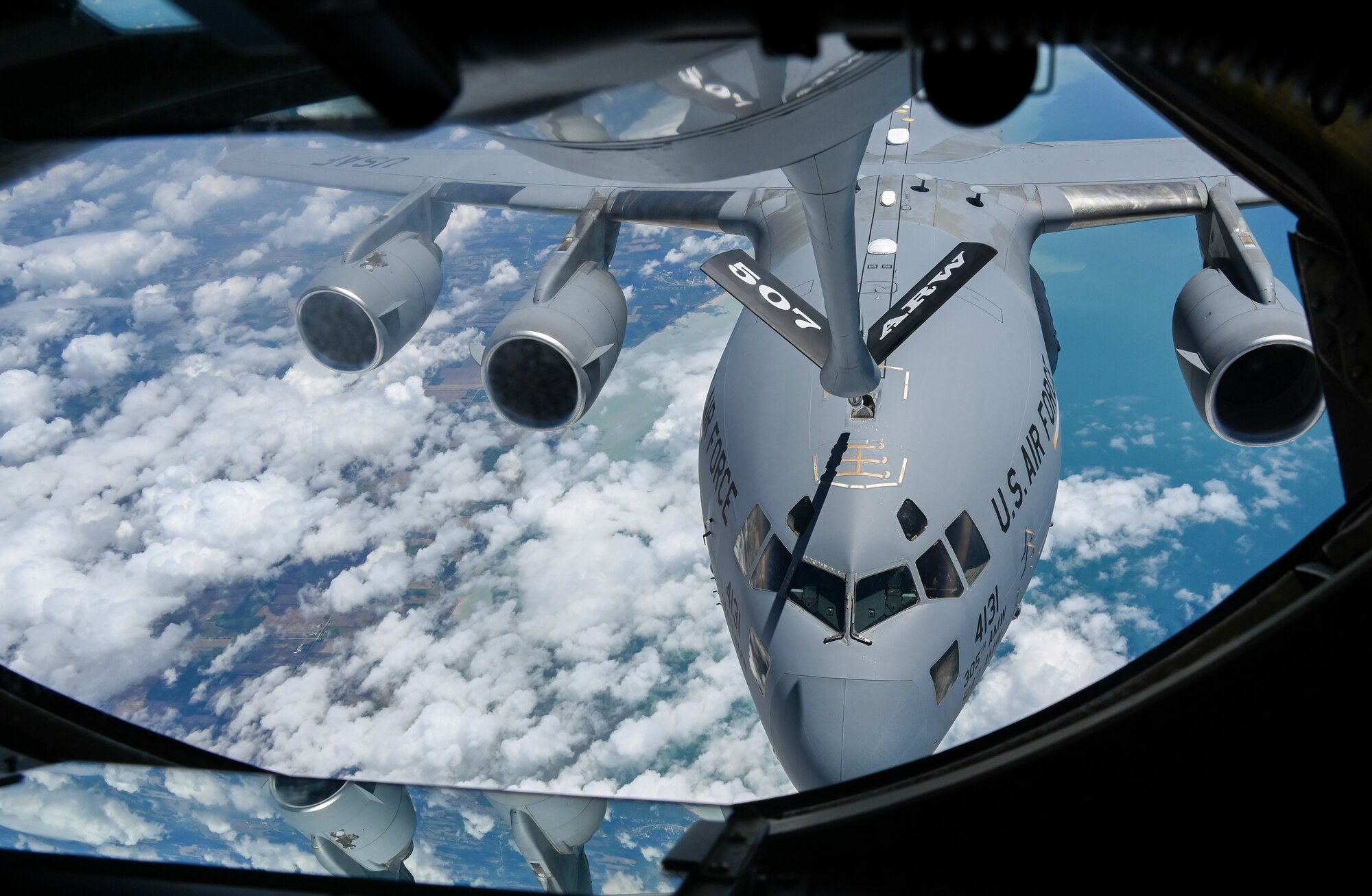 A C-17 Globemaster assigned to the 305th Air Mobility Wing, Joint Base McGuire-Dix-Lakehurst, New Jersey, refuels with a KC-135 Stratotanker from the 465th Air Refueling Squadron, Tinker Air Force Base, Oklahoma, over the Atlantic Ocean, June 9, 2022. (U.S. Air Force photo by 2nd Lt. Mary Begy)