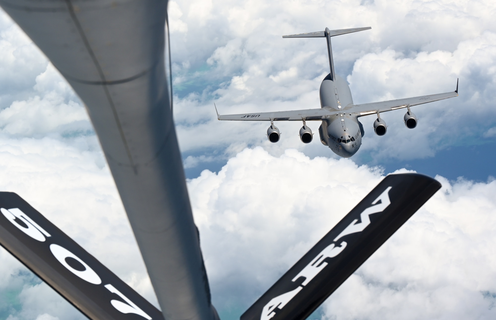 A C-17 Globemaster assigned to the 305th Air Mobility Wing, Joint Base McGuire-Dix-Lakehurst, New Jersey, refuels with a KC-135 Stratotanker from the 465th Air Refueling Squadron, Tinker Air Force Base, Oklahoma, over the Atlantic Ocean, June 9, 2022. (U.S. Air Force photo by 2nd Lt. Mary Begy)