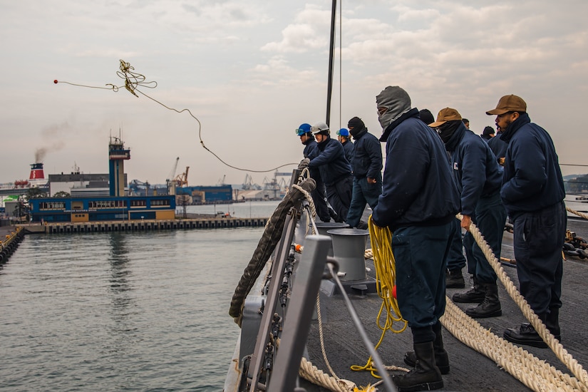 A sailor heaves a line.