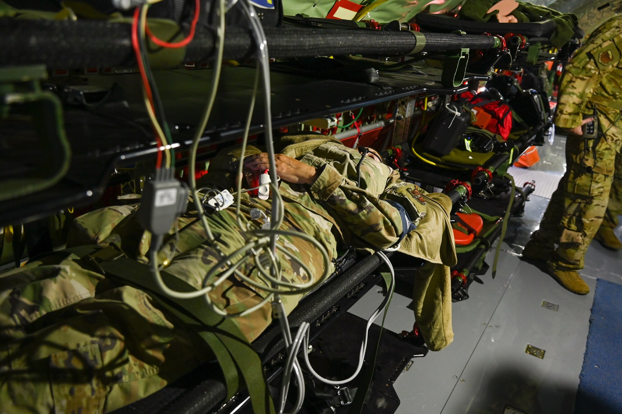 Aeromedical evacuation technicians with the 137th Aeromedical Evacuation Squadron, treats a simulated patient during a casualty transportation scenario on a 507th Air Refueling Wing KC-135 Stratotanker from the 507th Air Refueling Wing, Tinker Air Force Base, Okla., June 9, 2022. (U.S. Air Force photo by Master Sgt. Grady L. Epperly/Released)