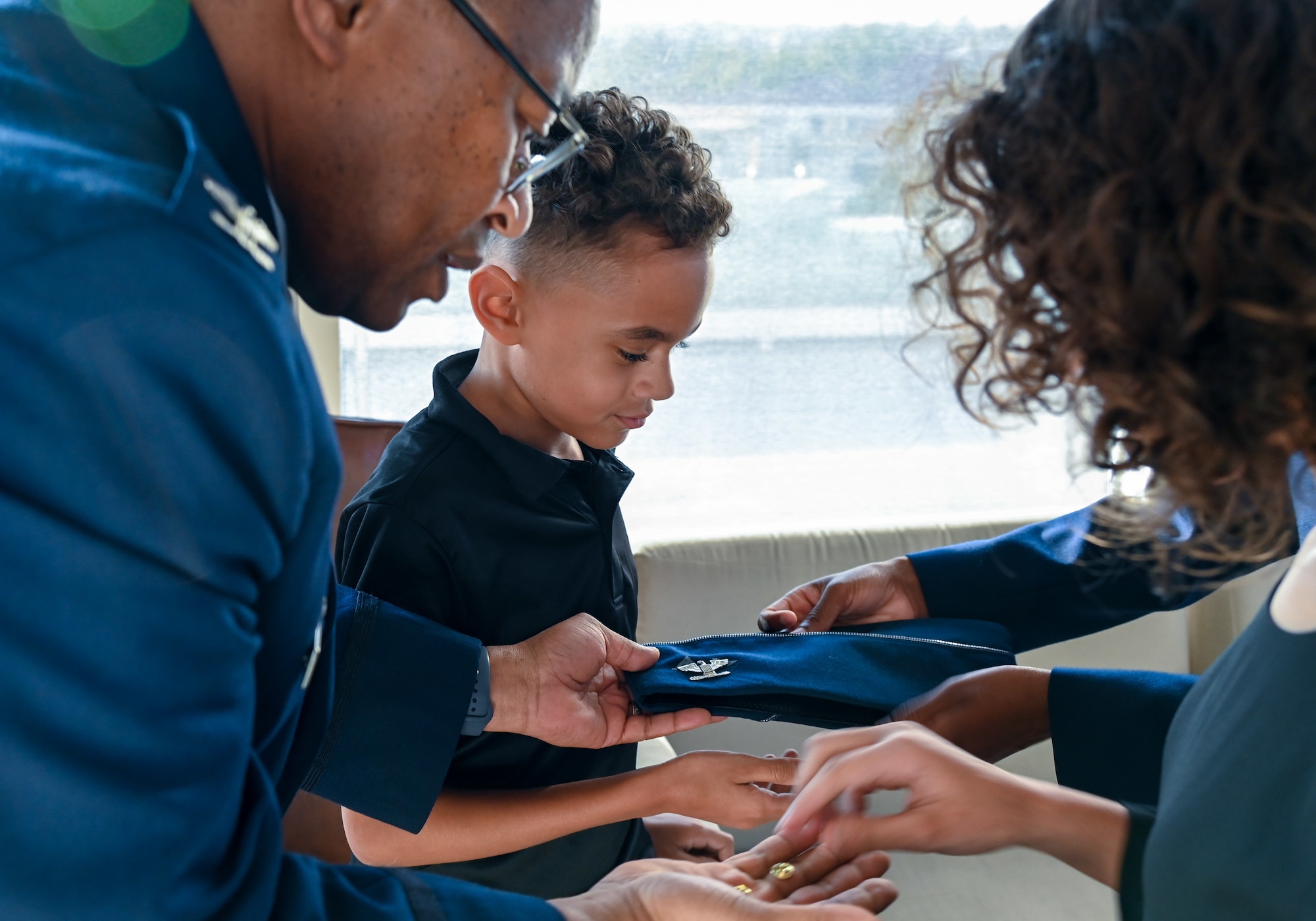 Members of Lt. Col. Alvin Bradford's, 507th Medical Squadron commander, family pin on the rank of colonel to Bradford's cover during a promotion ceremony September 30, 2022, Oklahoma City, Oklahoma. (U.S. Air Force photo by 2nd Lt. Mary Begy)