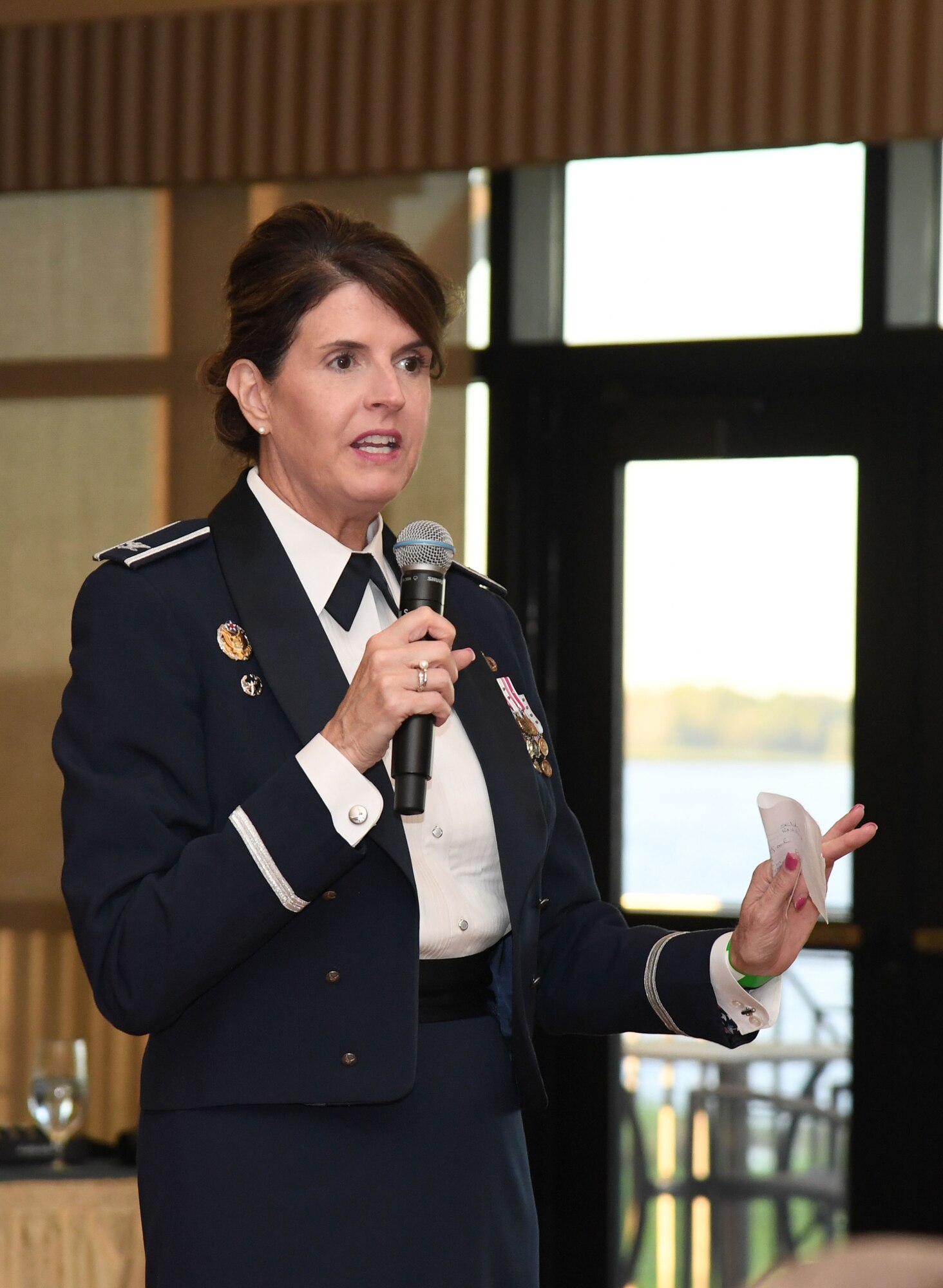 U.S. Air Force Col. Laura King, 81st Training Group commander, delivers remarks during the 81st Training Group Airman's Ball inside the Bay Breeze Event Center at Keesler Air Force Base, Mississippi, Sept. 30, 2022. The event was geared toward Airmen in training on how to participate and act during a formal military ball so they can feel confident in their abilities when arriving at their follow-on locations. The Airmen served in key positions throughout the ball such as emcees, color guard, POW/MIA table ceremony, national anthem singer and the invocation. (U.S. Air Force photo by Kemberly Groue)