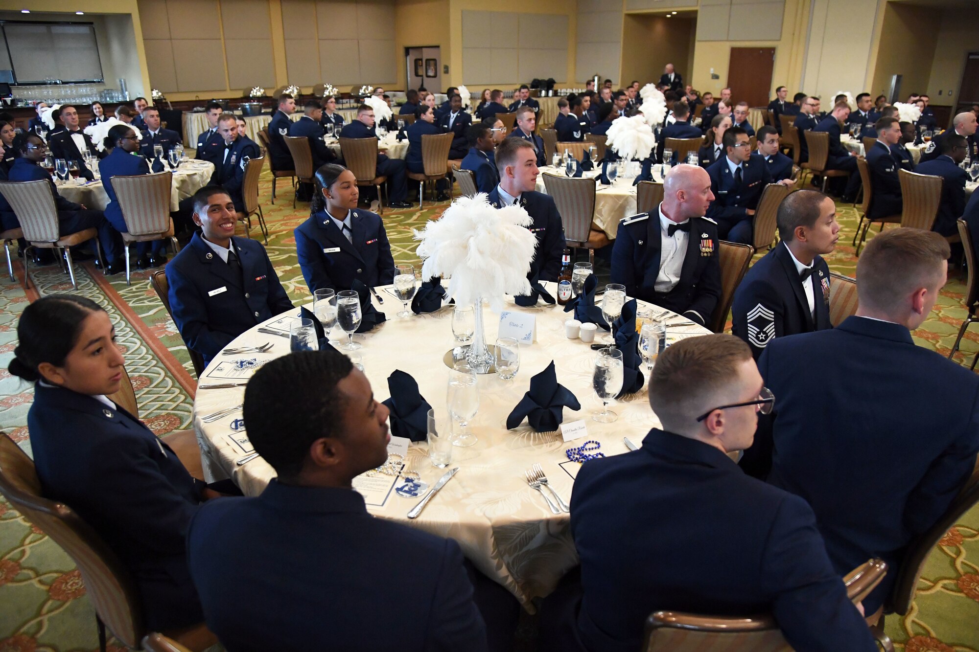 Airmen from the 81st Training Group attend the 81st Training Group Airman's Ball inside the Bay Breeze Event Center at Keesler Air Force Base, Mississippi, Sept. 30, 2022. The event was geared toward Airmen in training on how to participate and act during a formal military ball so they can feel confident in their abilities when arriving at their follow-on locations. The Airmen served in key positions throughout the ball such as emcees, color guard, POW/MIA table ceremony, national anthem singer and the invocation. (U.S. Air Force photo by Kemberly Groue)