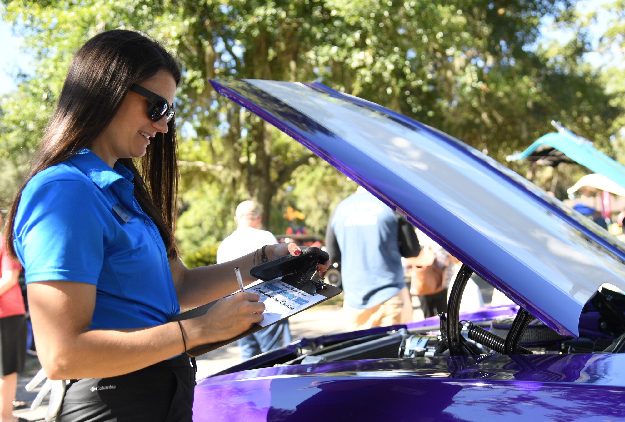 U.S. Air Force Lt. Col. Katherine Kuc, 81st Force Support Squadron commander, judges vehicles during the 19th Annual Cruisin' Keesler Car Show and Parade at the Marina Park at Keesler Air Force Base, Mississippi, October 1, 2022. The event is held to kick off Cruisin' the Coast, a festival to celebrate classic cars, trucks and hot rods, where vehicles cruise down the 30-mile beachside highway in Mississippi. (U.S. Air Force photo by Kemberly Groue)