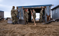 Alaska Air and Army National Guardsmen from Joint Task Force-Alaska rebuild the door of a small garage in Golovin, Alaska, Sept. 27, 2022. More than 130 members of the Alaska Organized Militia, which includes members of the Alaska National Guard, Alaska State Defense Force and Alaska Naval Militia, were activated following a disaster declaration issued Sept. 17 after the remnants of Typhoon Merbok caused dramatic flooding across more than 1,000 miles of Alaskan coastline. (Alaska National Guard photo by Pfc. Bradford Jackson)