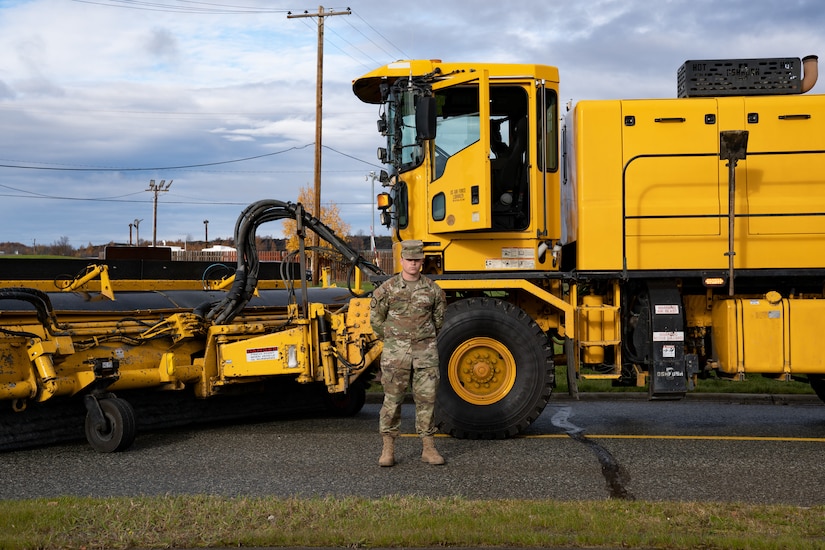 Photo of an Airman and a snow machine