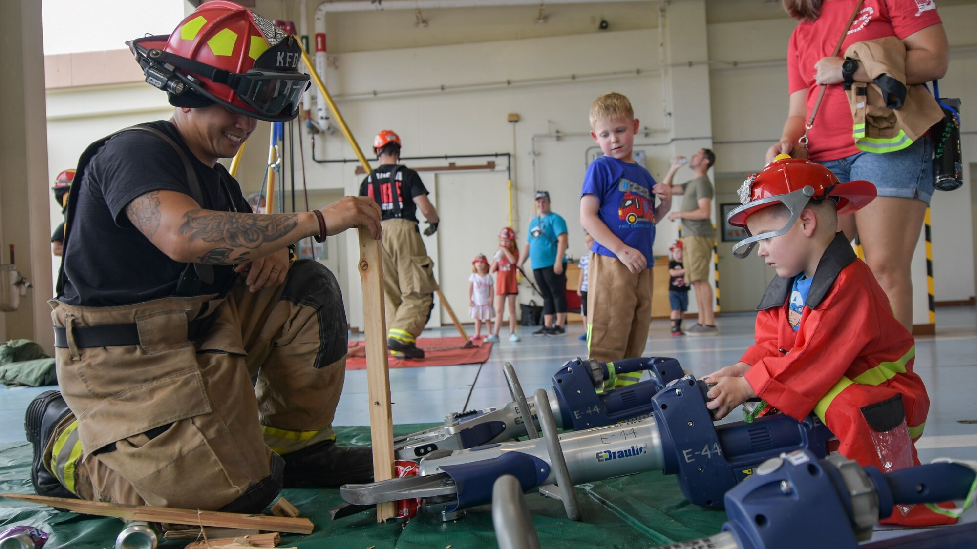 Firefighter demonstrates equipment to child