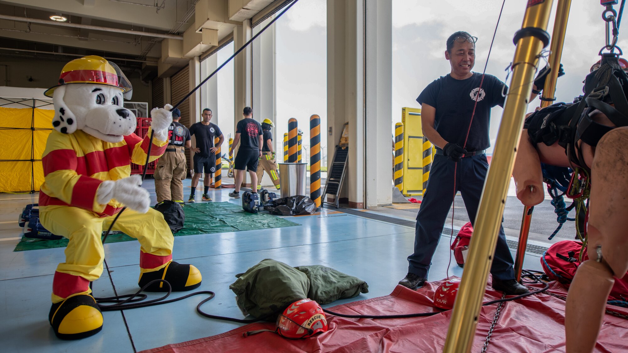 Sparky the Dog, a mascot, operates rescue equipment at the Fire Station 1 Open House