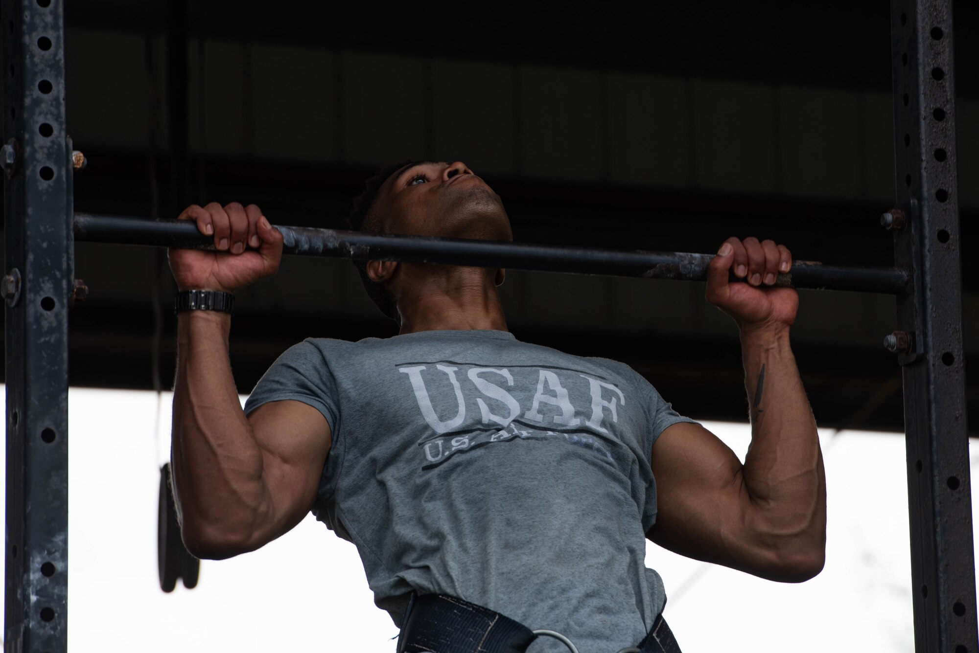 An Airman does pull-ups.