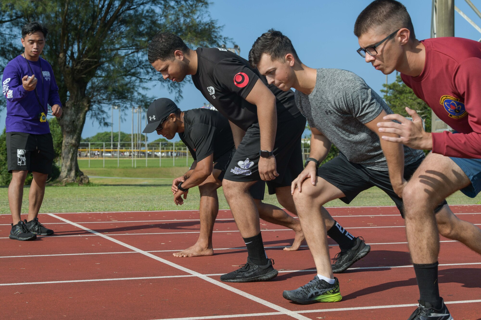 Airmen line up at the starting line for a race.