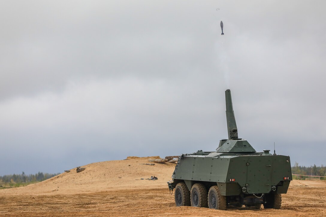 A NATO Enhanced Forward Presence Battle Group vehicle fires a mortar round as part of a live-fire demonstration at the closing event for Exercise Silver Arrow 2022 at Camp Adazi, Latvia, Sept. 29, 2022. Multiple NATO allies are proudly working alongside 1st Infantry Division and regional security partners to provide combat-credible forces to V Corps, America's forward deployed corps in Europe. (U.S. Army National Guard photo by Sgt. Lianne M. Hirano)