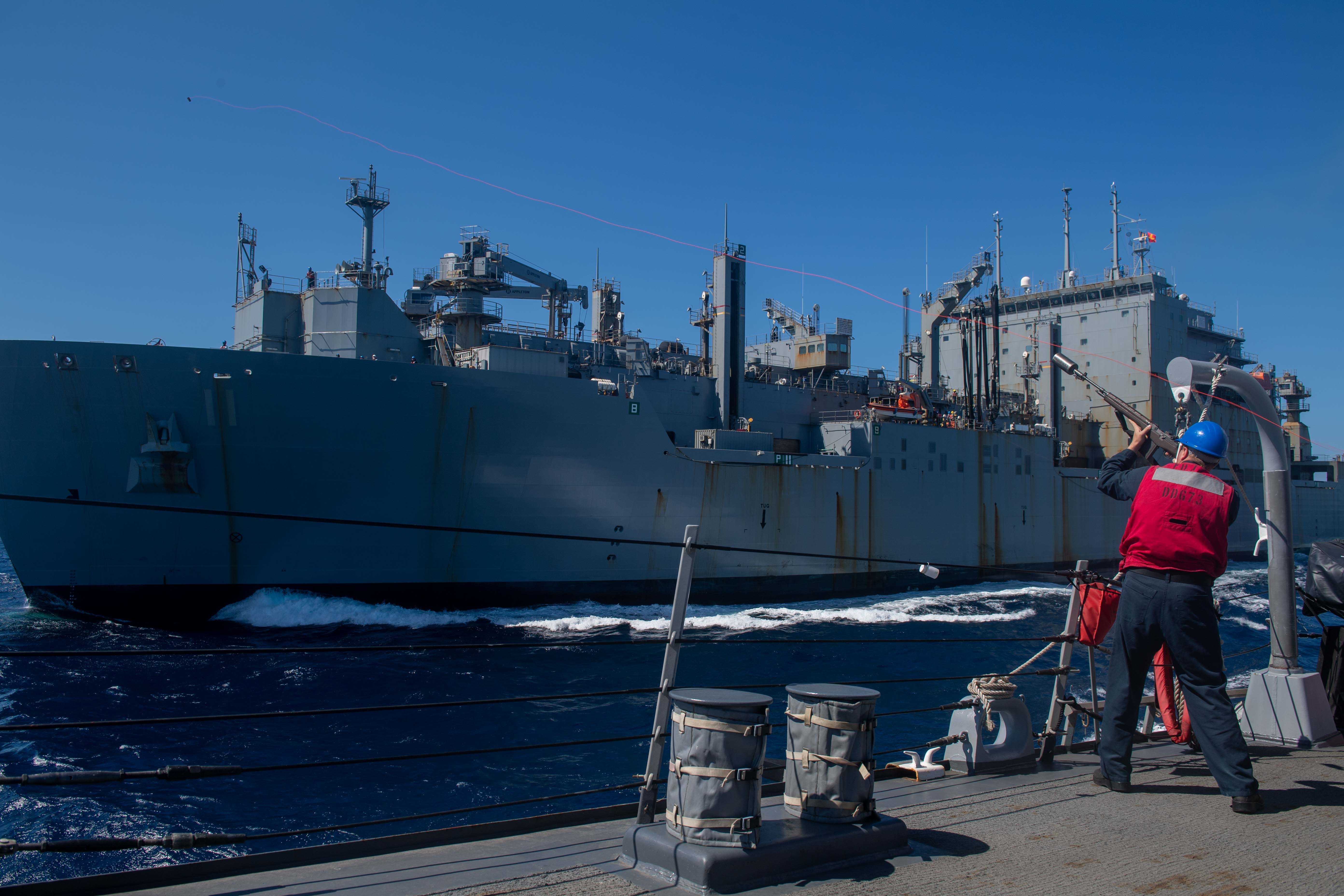 PACIFIC OCEAN (Sept. 25, 2022) U.S. Navy Gunner's Mate 3rd Class Colin Arndt, from Lowell, Iowa, fires a line to the fleet replenishment oiler USNS Washington Chambers (T-AO 11) during an underway replenishment (UNREP) aboard the Arleigh Burke-class guided-missile destroyer USS Decatur (DDG 73).