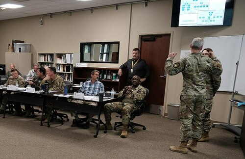 photo of US military personnel sitting at a table