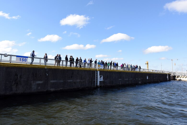 A large group of Tellico Village New Villagers look into the lock chamber during a tour Sept. 29, 2022, at Fort Loudoun Lock on the Tennessee River in Lenoir City, Tennessee. (USACE Photo by Lee Roberts)