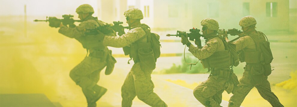 U.S. Marines assigned to Fleet Anti-Terrorism Security Team Central Command (FASTCENT) maneuver through a street using smoke grenades for concealment while conducting squad level training during exercise Neon Defender 22 in Bahrain, May 17.