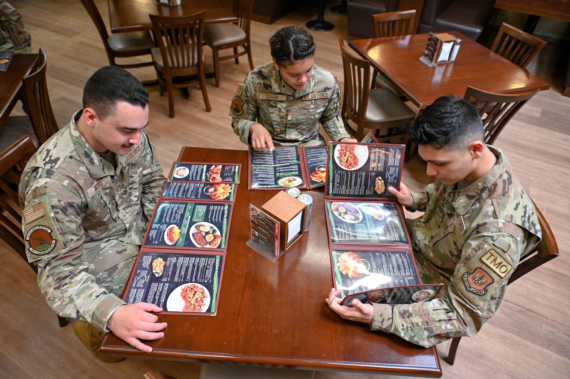 Airmen assigned to the 39th Air Base Wing look at the American Roadhouse menu as they are the first airmen to utilize the campus style dining at the Club Complex on Incirlik Air Base, Turkey, Aug. 26, 2022. This expansion of dining options allows for Airmen with meal cards to utilize them at all FSS dining facilities. The Air Force Campus Style Dining System collaborated with Incirlik AB to implement this pilot program, making Incirlik AB the first base in USAFE-AFAFRICA to introduce campus style dining. (U.S. Air Force photo by Senior Airman Joshua T. Crossman)