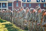 Indiana National Guard Soldiers with the 76th Infantry Brigade Combat Team pause for a moment of reflection during their departure ceremony at Camp Atterbury near Edinburgh Sept. 30, 2022. The Soldiers are deploying to Kosovo.